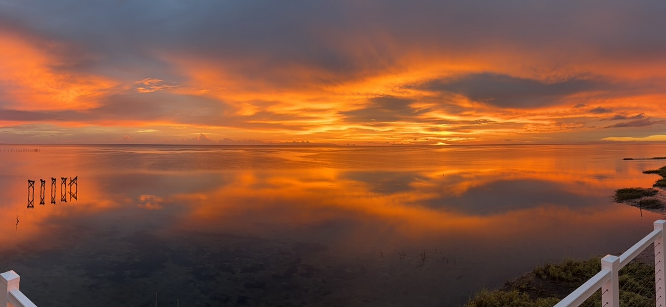 Sunset reflected across the water at Analemma